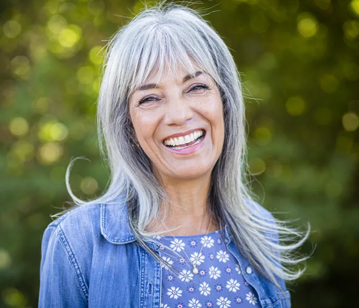 happy senior woman with white hair and great teeth