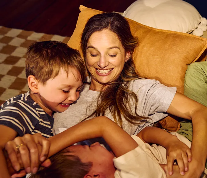 Happy family enjoying quality time together, playing and laughing on the sofa