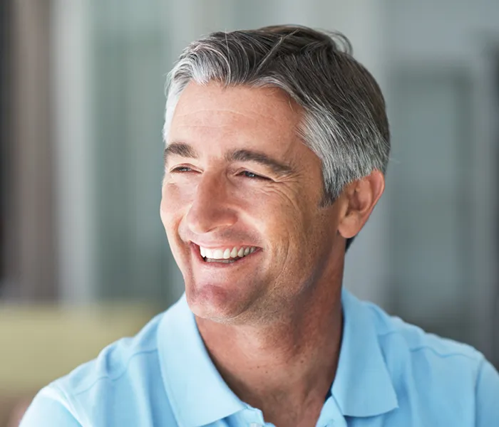 mature man at home smiling and laughing